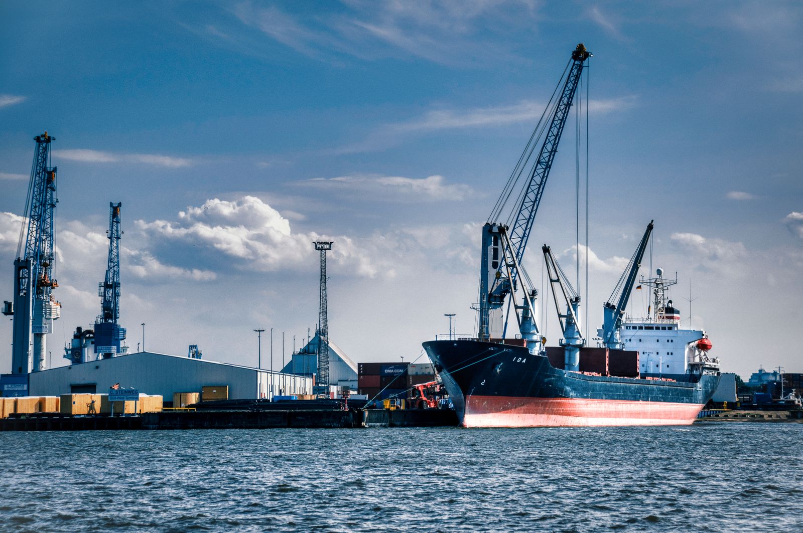 pexels-partners-ship Cargo ship at harbor under blue sky, representing global sourcing